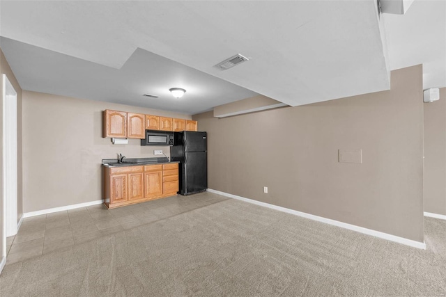 kitchen featuring baseboards, black appliances, visible vents, and light colored carpet