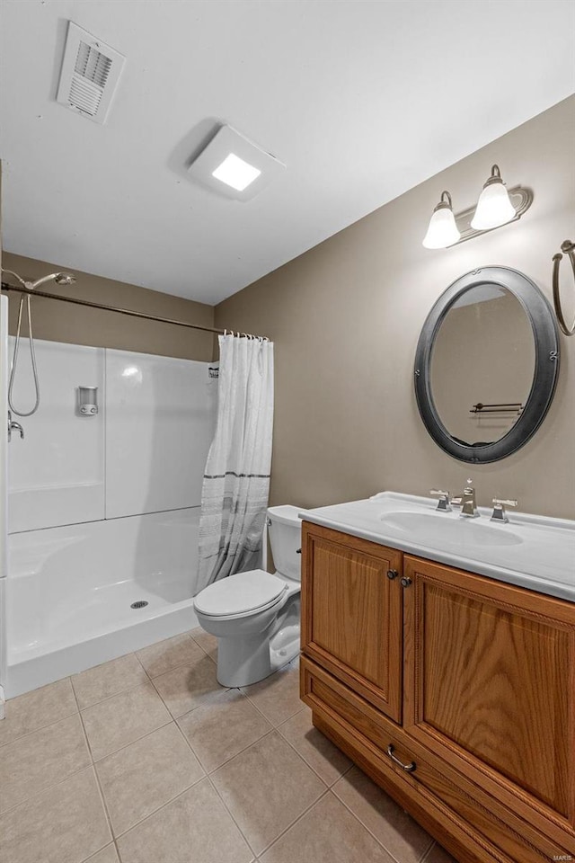 bathroom featuring visible vents, toilet, a shower with shower curtain, vanity, and tile patterned floors