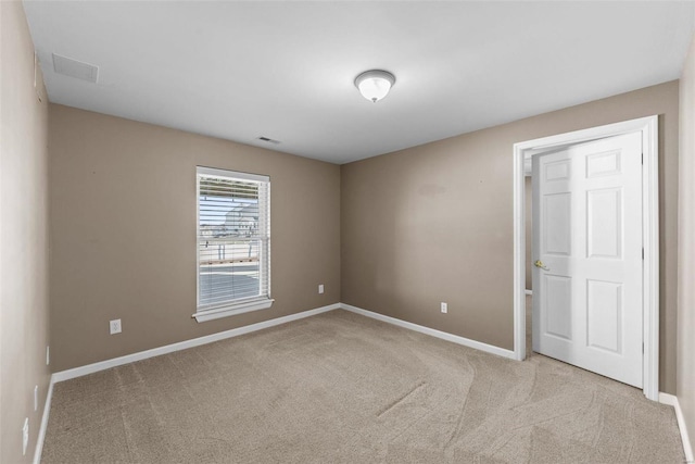 carpeted empty room with baseboards and visible vents