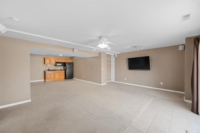 unfurnished living room featuring light carpet, visible vents, a ceiling fan, and baseboards