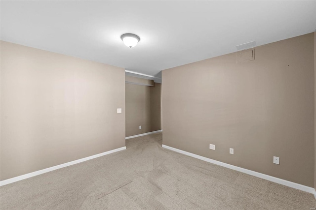 carpeted spare room with baseboards