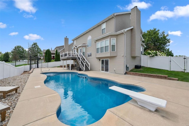 view of swimming pool featuring a patio, a fenced backyard, stairway, a gate, and a fenced in pool