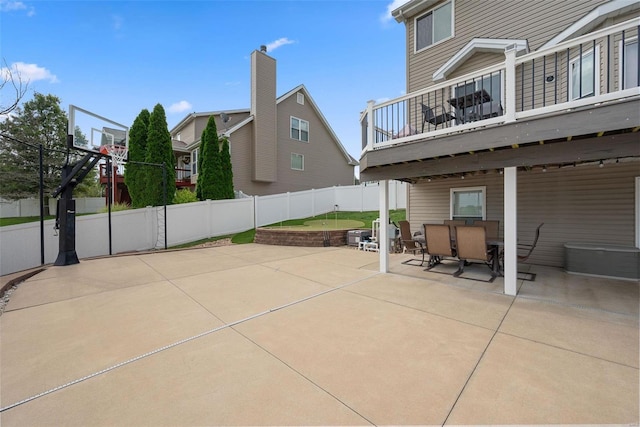 view of patio featuring outdoor dining space and fence