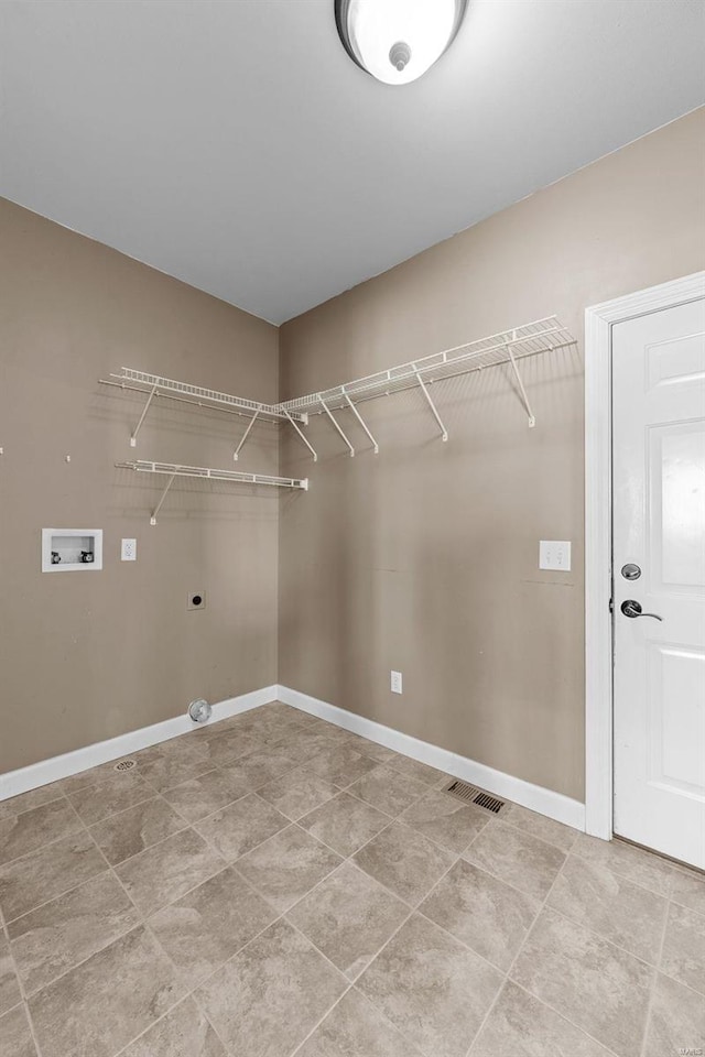 laundry area with laundry area, washer hookup, visible vents, baseboards, and electric dryer hookup