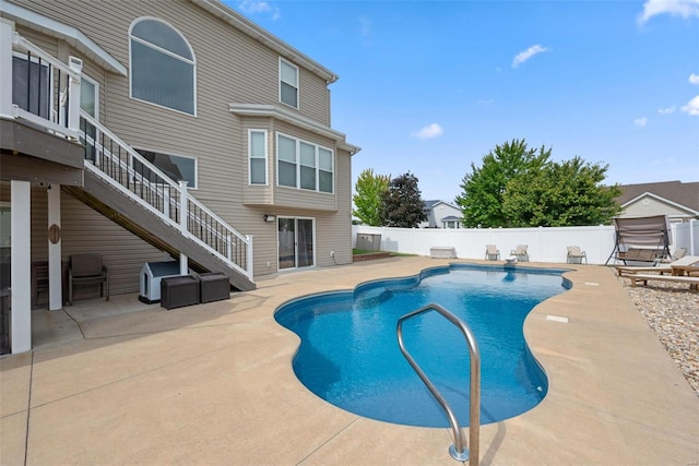 view of pool featuring a fenced in pool, stairway, a patio area, a fenced backyard, and a diving board