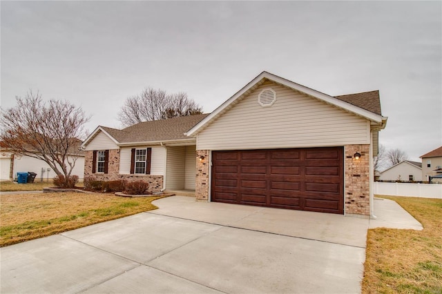 ranch-style home with a garage and a front lawn