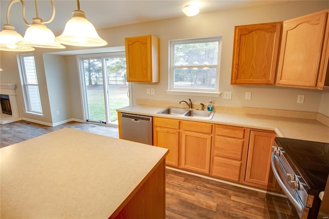 kitchen with dark hardwood / wood-style flooring, sink, hanging light fixtures, and appliances with stainless steel finishes