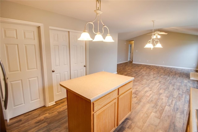 kitchen featuring vaulted ceiling, decorative light fixtures, a center island, and hardwood / wood-style floors