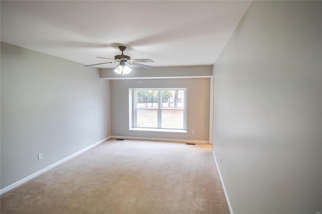 empty room with light colored carpet and ceiling fan