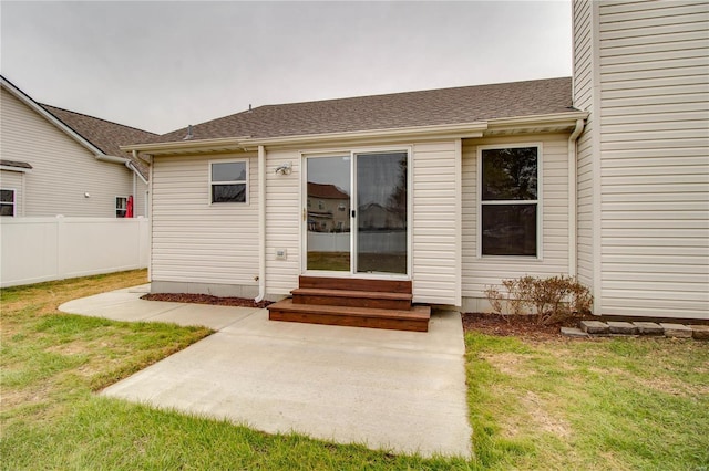 property entrance with a yard and a patio