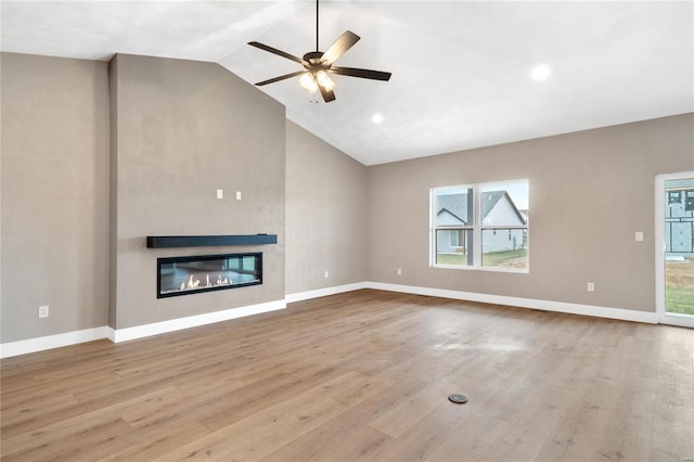 unfurnished living room with light hardwood / wood-style flooring, high vaulted ceiling, and ceiling fan