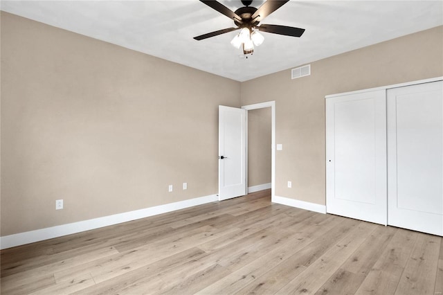 unfurnished bedroom with a closet, ceiling fan, and light hardwood / wood-style flooring