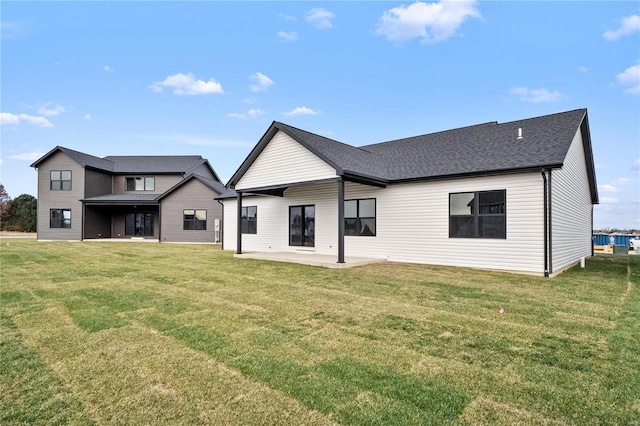 back of property with a yard and a patio area