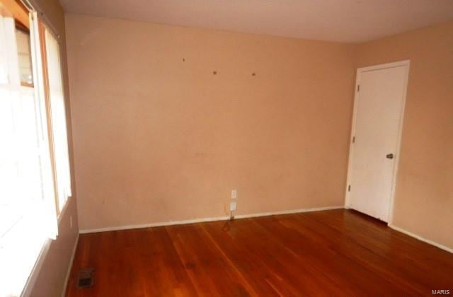 unfurnished room with hardwood / wood-style flooring and plenty of natural light