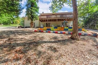 back of property featuring a deck