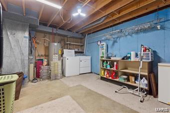 basement with water heater and separate washer and dryer