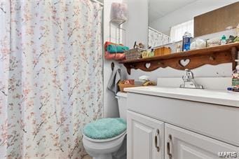 bathroom featuring vanity, walk in shower, and toilet