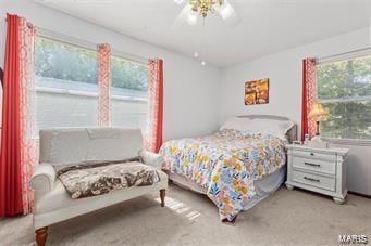 bedroom with light colored carpet and ceiling fan