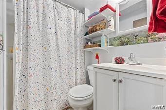 bathroom featuring vanity, a shower with curtain, and toilet