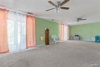 spare room featuring ceiling fan and carpet