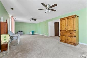 sitting room featuring light carpet and ceiling fan