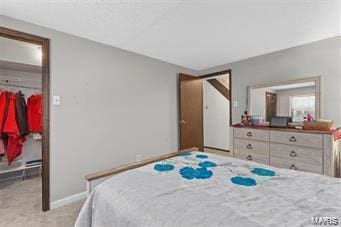 carpeted bedroom featuring a walk in closet and a closet