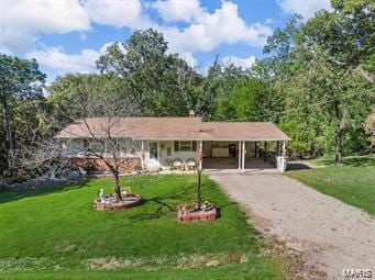 ranch-style house with a carport and a front lawn