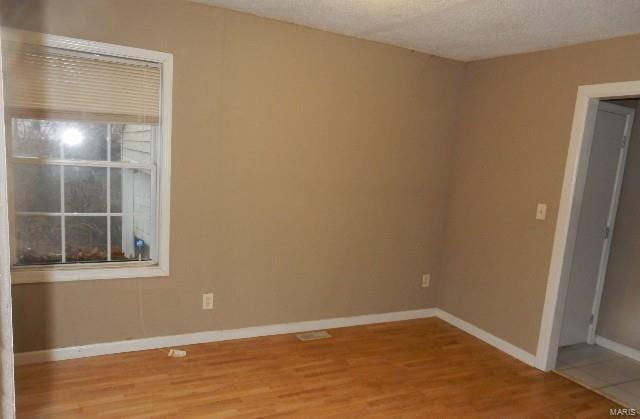 empty room featuring wood-type flooring