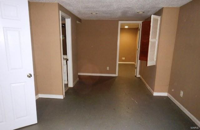 hallway featuring a textured ceiling