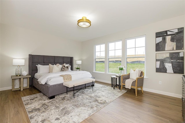 bedroom featuring baseboards and wood finished floors