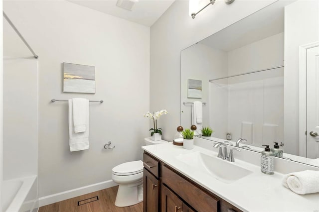 full bathroom featuring toilet, wood finished floors, vanity, bathing tub / shower combination, and baseboards