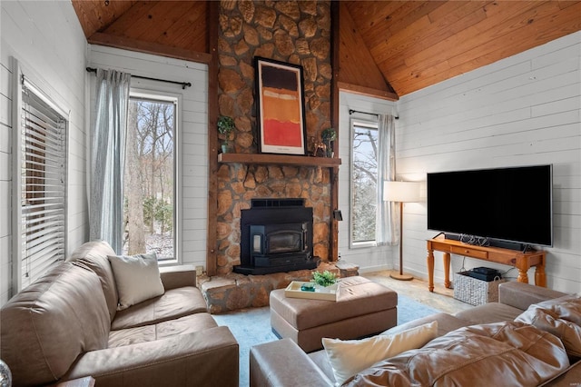 living room featuring high vaulted ceiling, wood ceiling, wooden walls, and a wood stove