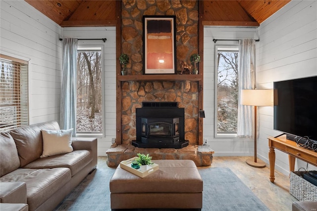 living area with lofted ceiling, a wood stove, and wooden walls