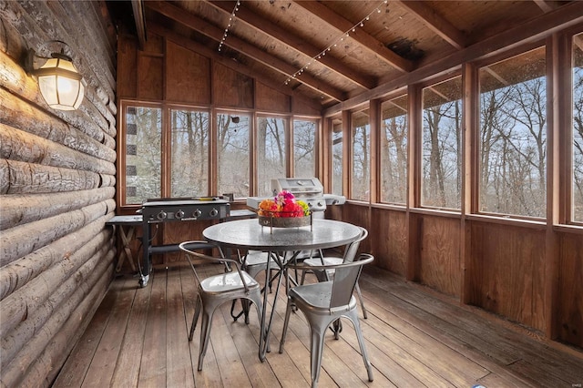 sunroom with wooden ceiling and lofted ceiling with beams