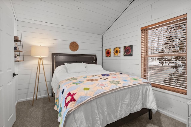 carpeted bedroom featuring lofted ceiling, wooden walls, and baseboards