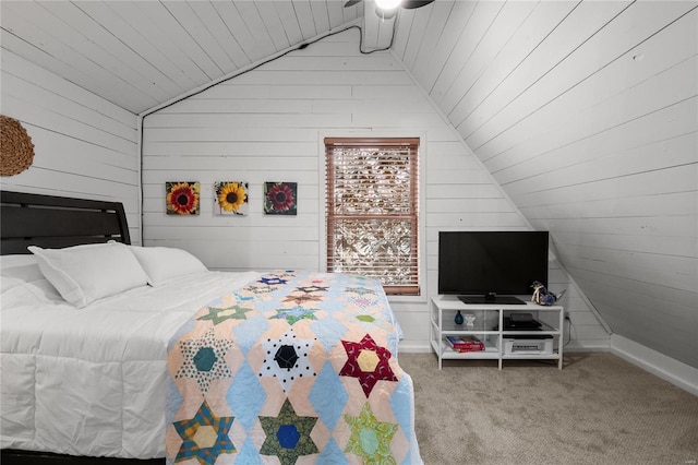 bedroom with vaulted ceiling, carpet, wood ceiling, and wooden walls