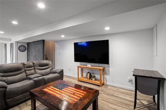 living area with baseboards, wood finished floors, and recessed lighting