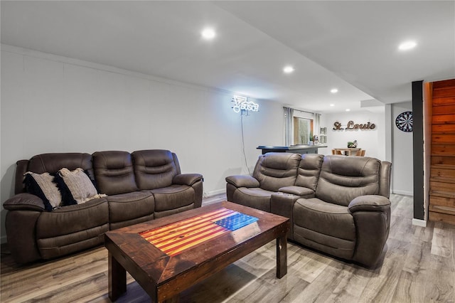 living area with recessed lighting and light wood finished floors