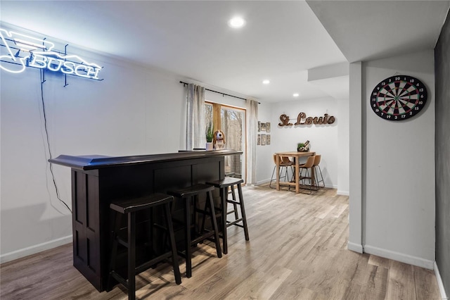 bar with a dry bar, light wood-style floors, baseboards, and recessed lighting