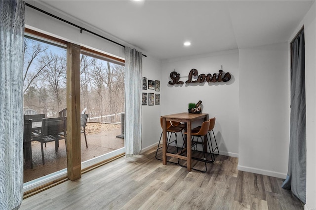 dining room featuring recessed lighting, baseboards, and wood finished floors