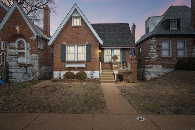 tudor house featuring a porch