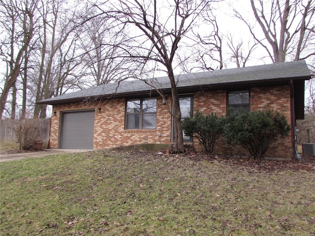 ranch-style home featuring a garage and a front lawn