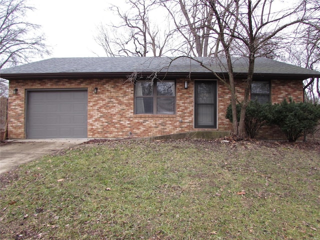 single story home featuring a garage and a front lawn