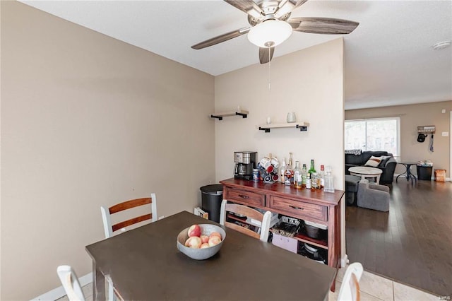 dining area with light hardwood / wood-style floors and ceiling fan