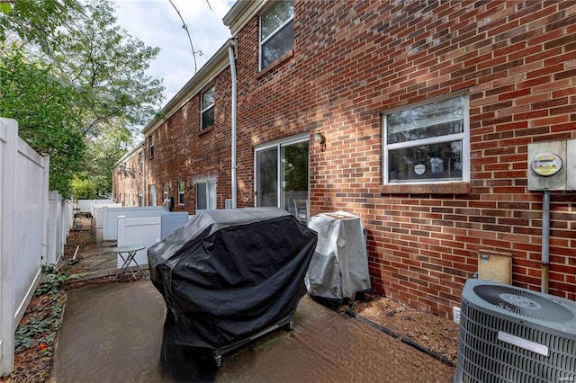 view of property exterior featuring cooling unit and a patio area