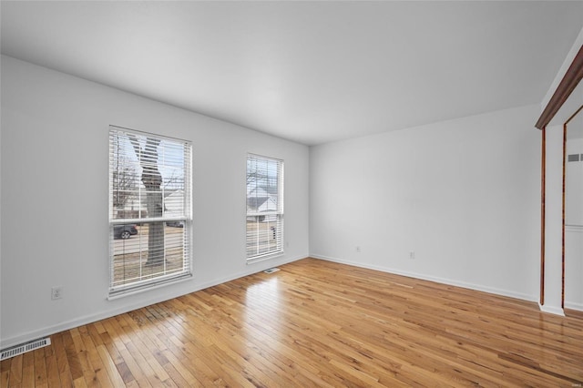 empty room with light hardwood / wood-style floors