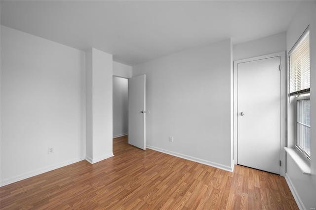 empty room with light hardwood / wood-style floors