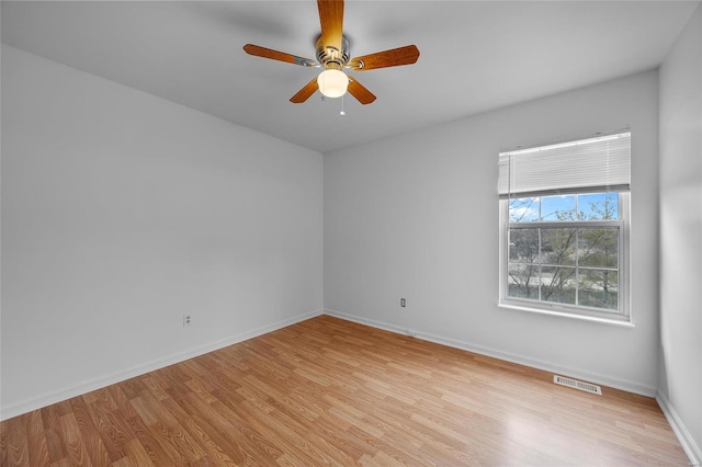 empty room with light hardwood / wood-style floors and ceiling fan