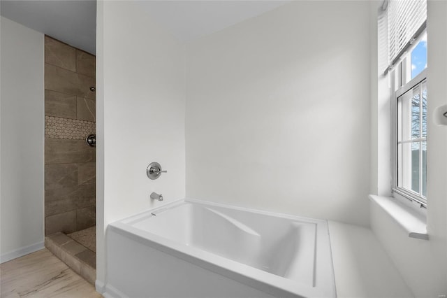 bathroom featuring separate shower and tub