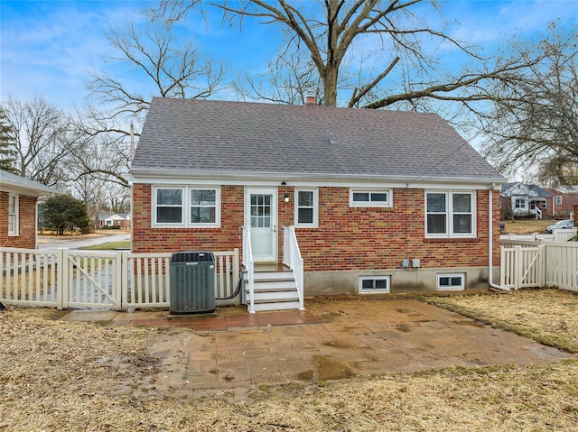 rear view of house with central AC and a patio